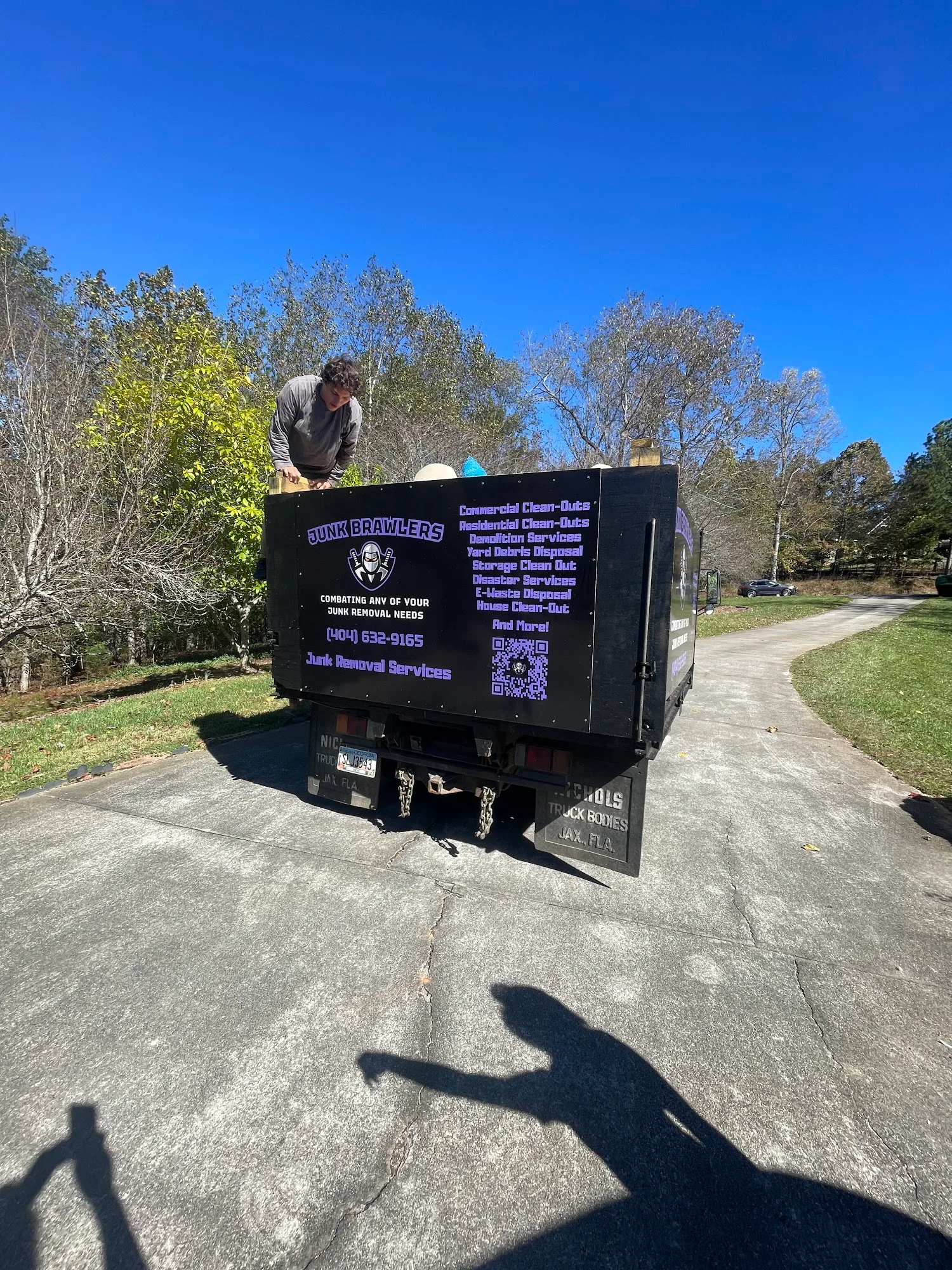 Junk Brawlers dump truck backed up a Dawsonville driveway, ready to load