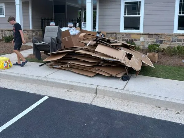 Cardboard and stacked chairs cleared from behind a downtown Woodstock business